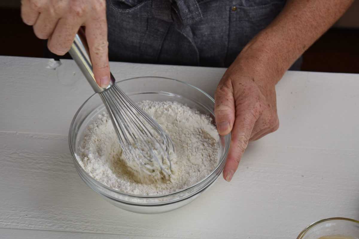 dry ingredients being mixed in a bowl with a whisk