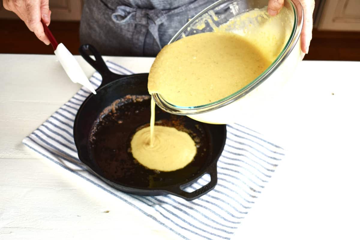 muffin batter being poured into a pan.