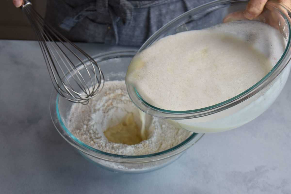 wet ingredients being added to dry ingredients to make crepes.