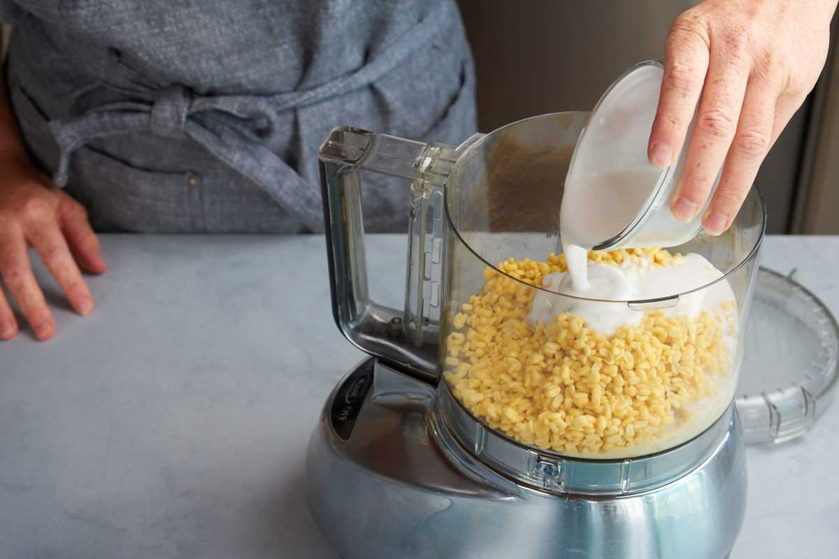 soaked dried mung beans and coconut milk in a blender ready to be pulsed.