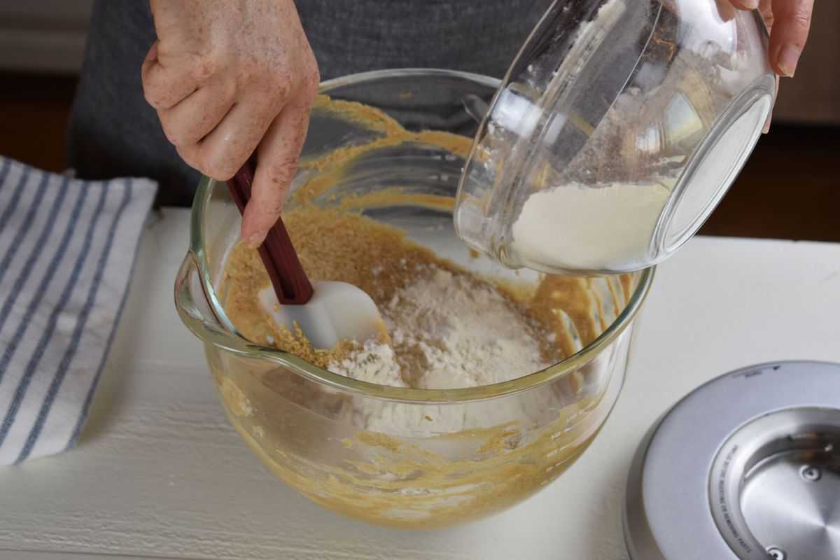 wet and dry ingredients being mixed in a bowl