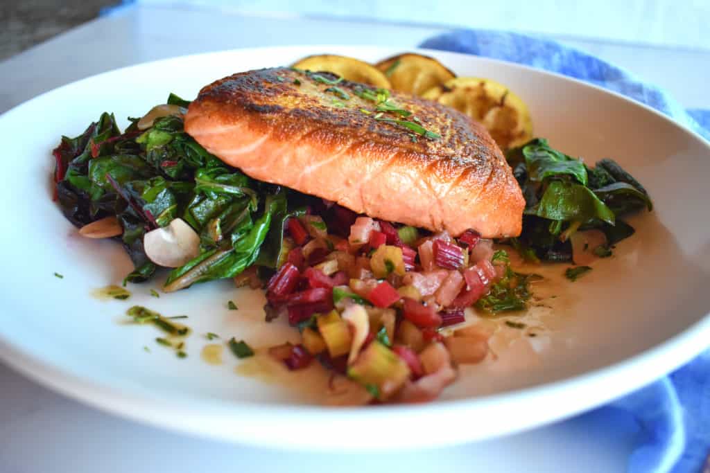 side shot of seared salmon with chard 