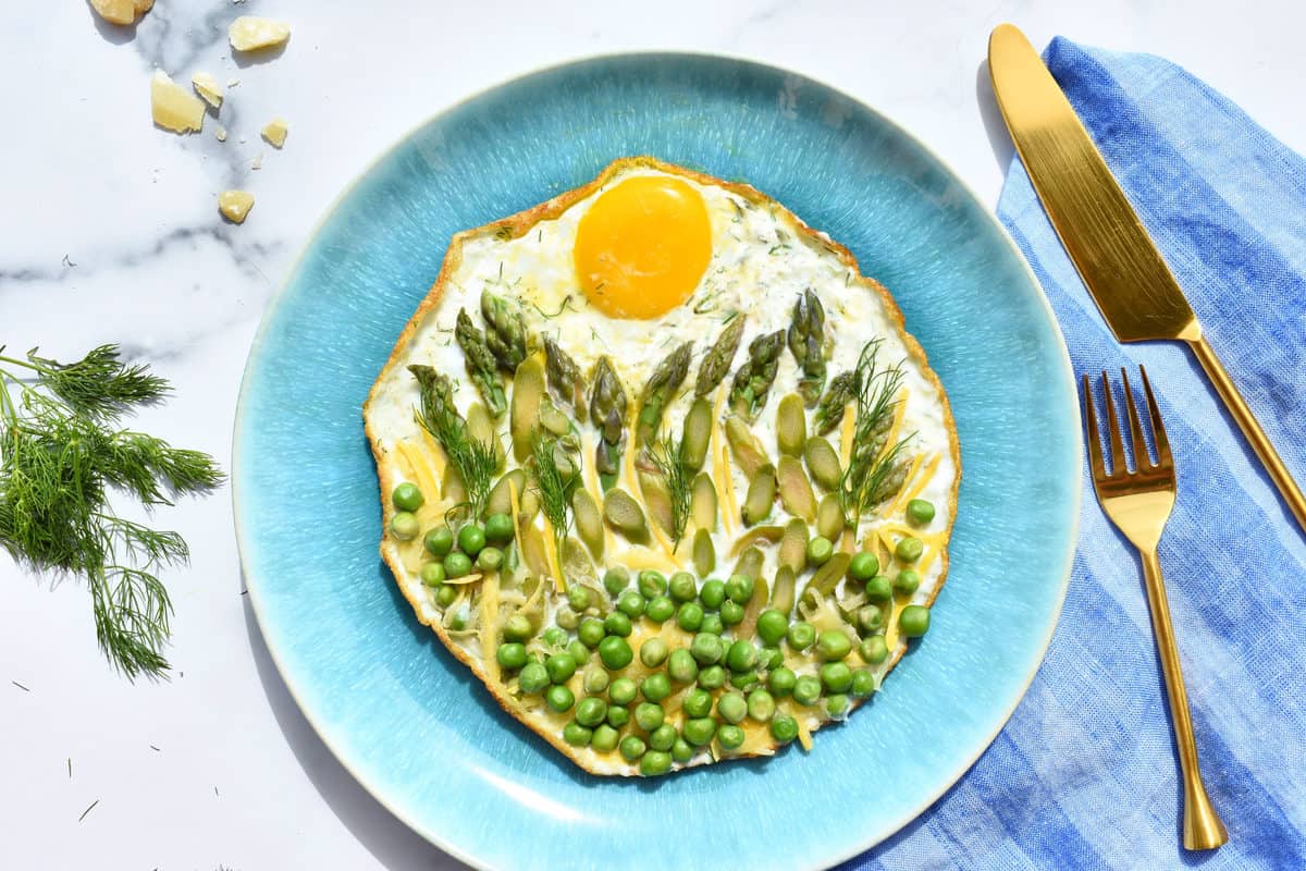 crispy fried egg sunrise: fried egg with asparagus and peas