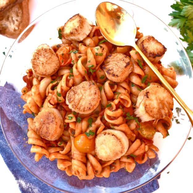 overhead shot of scallop fusilli with sunburst tomato marinara