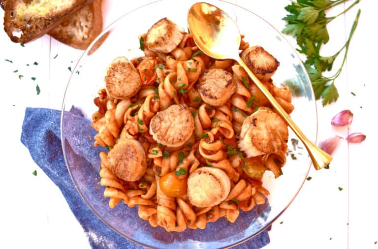 overhead shot of scallop fusilli with sunburst tomato marinara