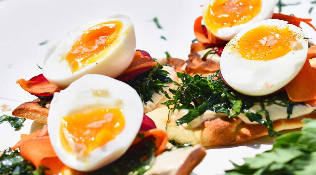 boiled eggs sliced and placed on flat bread