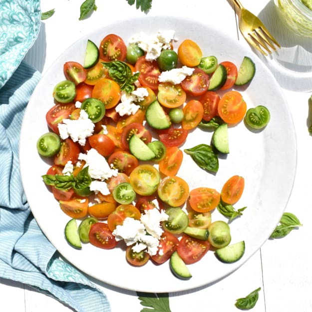 overhead shot of tomato, cucumber and avocado salad