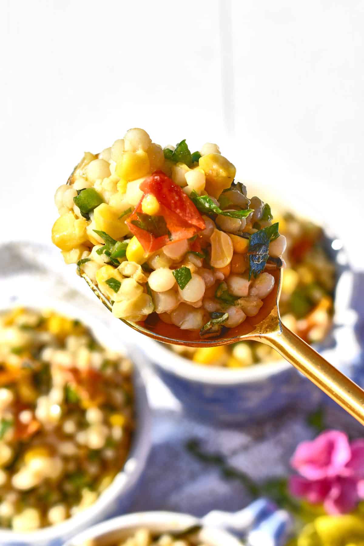 a spoonful of Warm Roasted Tomato, Corn, And Pepper Israeli Couscous