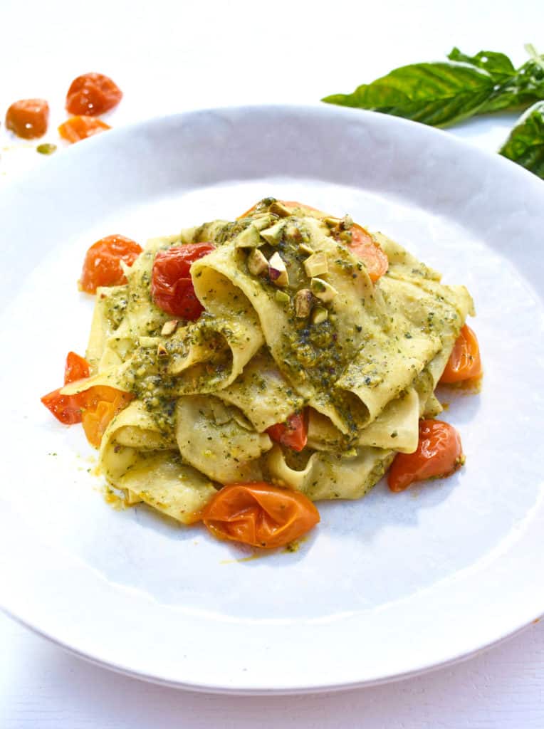 parpadelle pasta and tomatoes with pesto on a plate