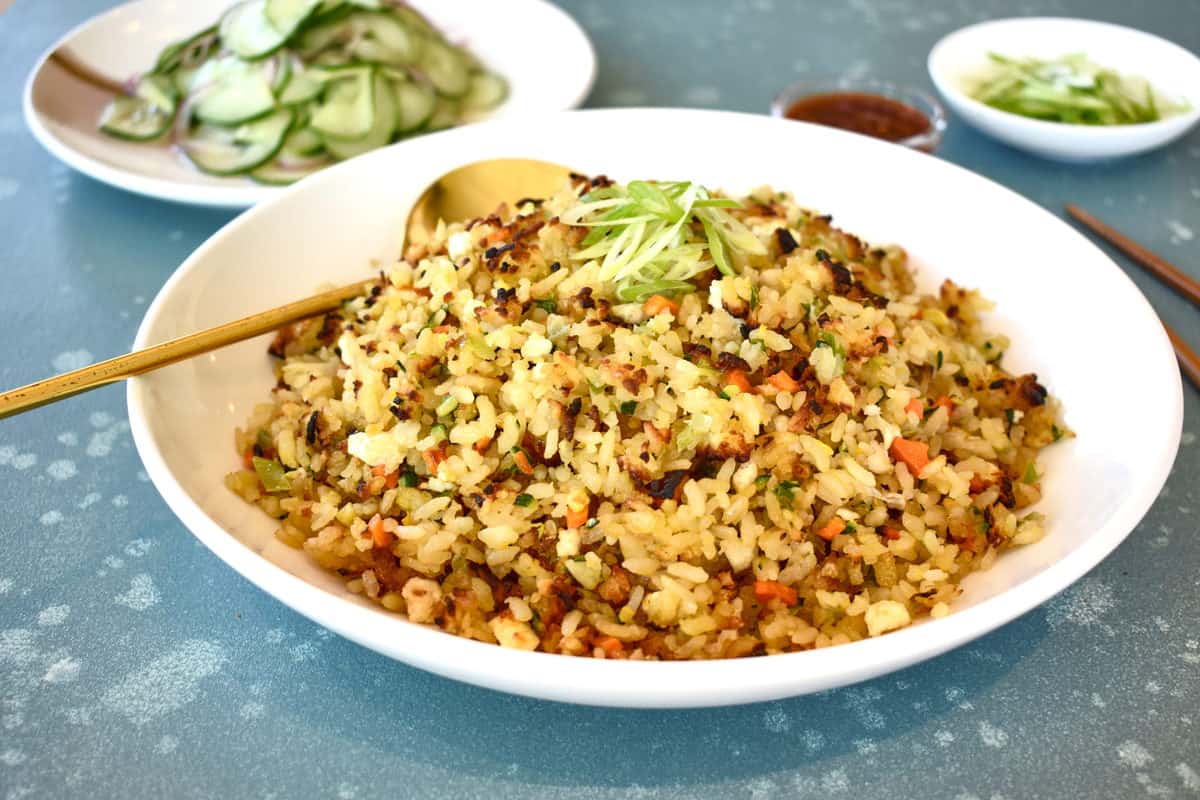 a bowl of vegetable rice with a spoon