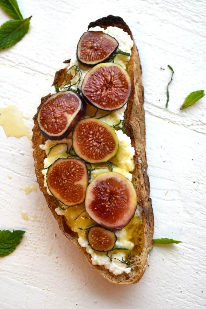 overhead shot of fig and ricotta toast with honey drizzle