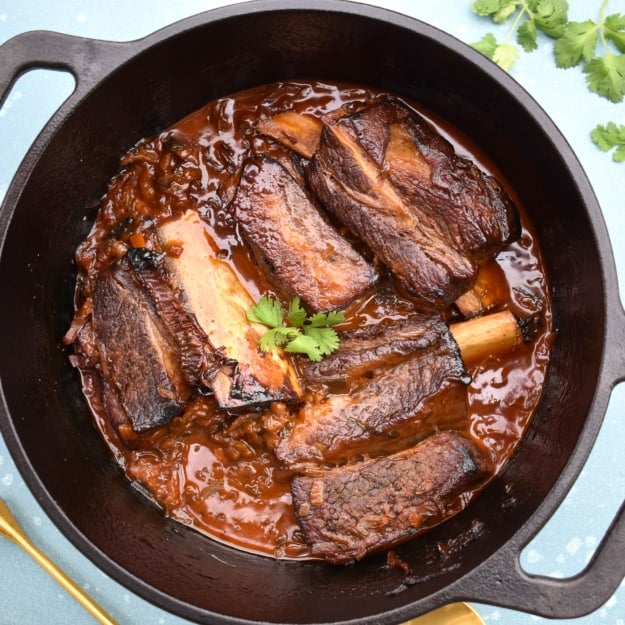 Whole Pot Close Up Spoon and Cilantro Korean Short Ribs