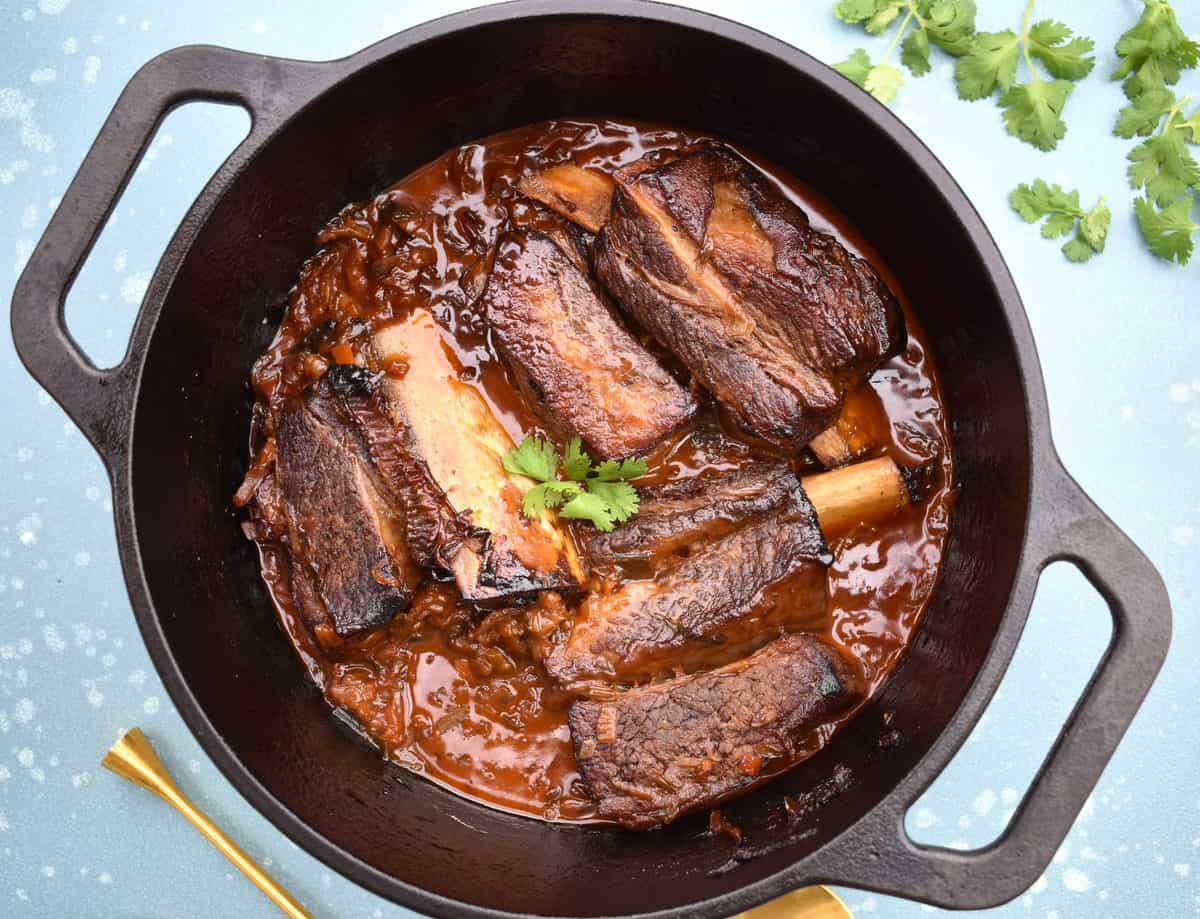 Whole Pot Close Up Spoon and Cilantro Korean Short Ribs