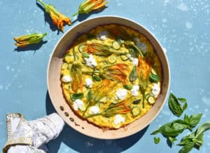 overhead shot of a frittata with squash blossom