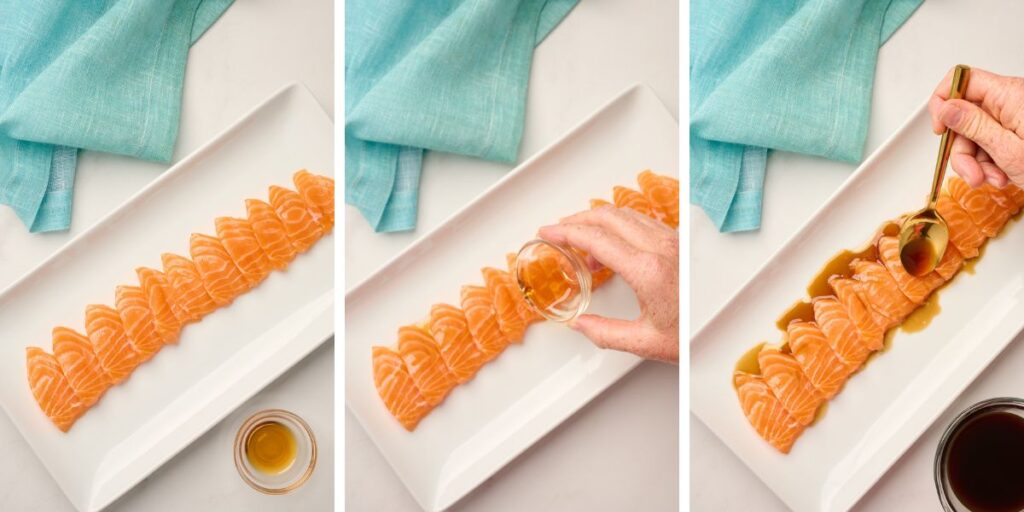 Plated salmon sashimi slices drizzled with sesame oil and yuzu soy sauce, styled with a blue linen napkin for an elegant presentation.