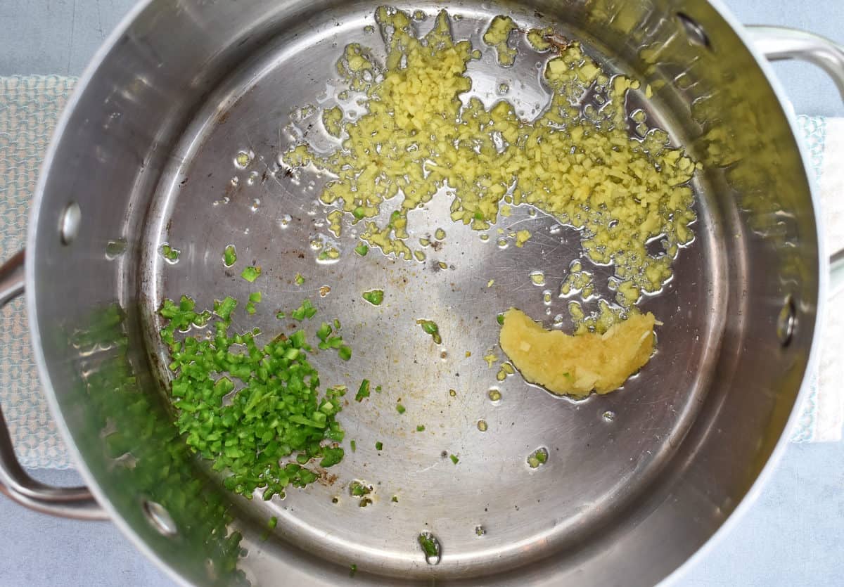 minced garlic, ginger and jalapeno frying in a pan