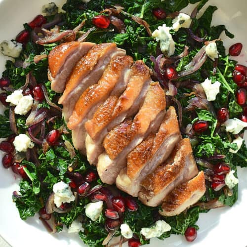 duck breast on a bed of wilted greens