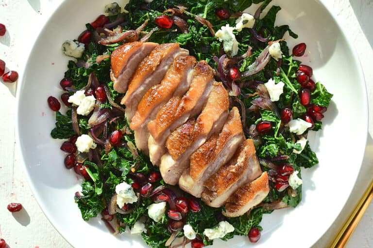 duck breast on a bed of wilted greens