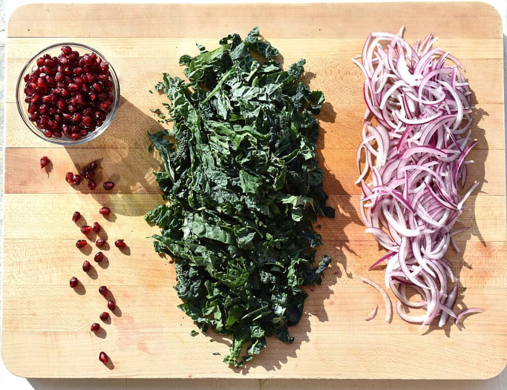 pomegranate seeds, kale and red onion sliced