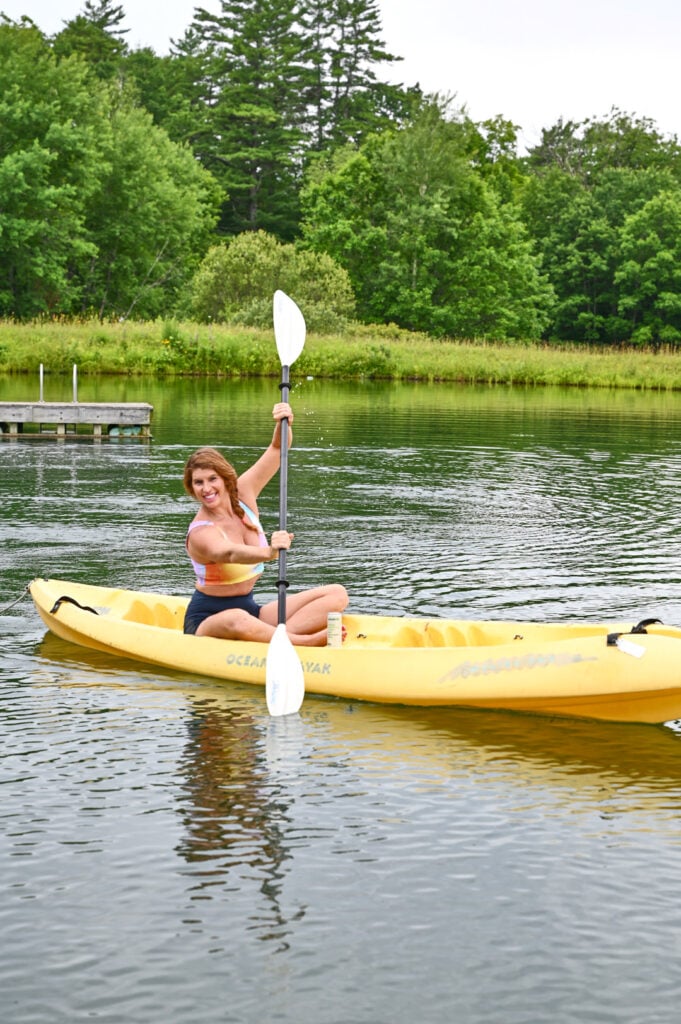 a lady in a canoe on a lake