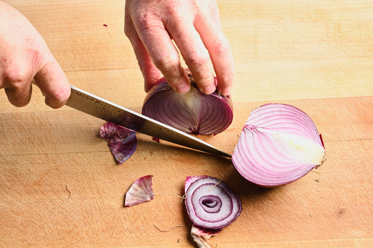 A red onion being halved