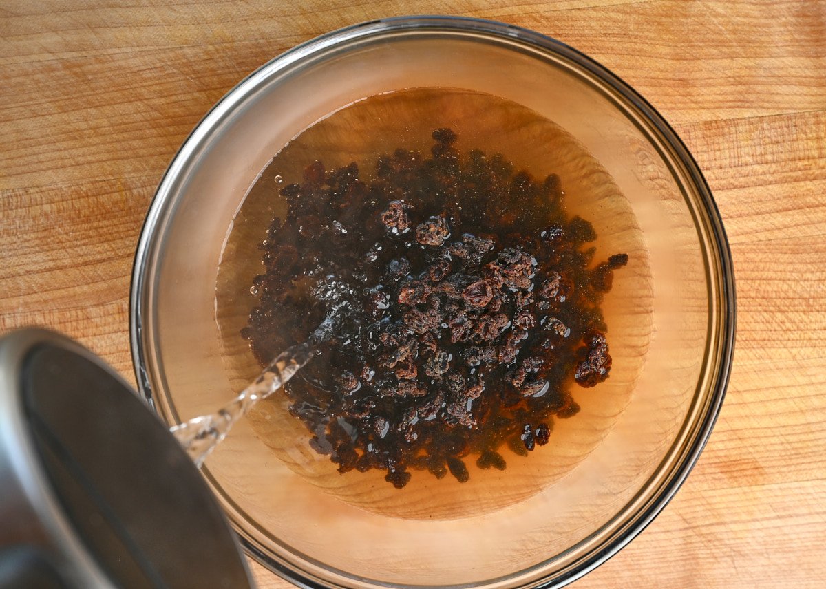 Rehydrating currants in a bowl of hot water