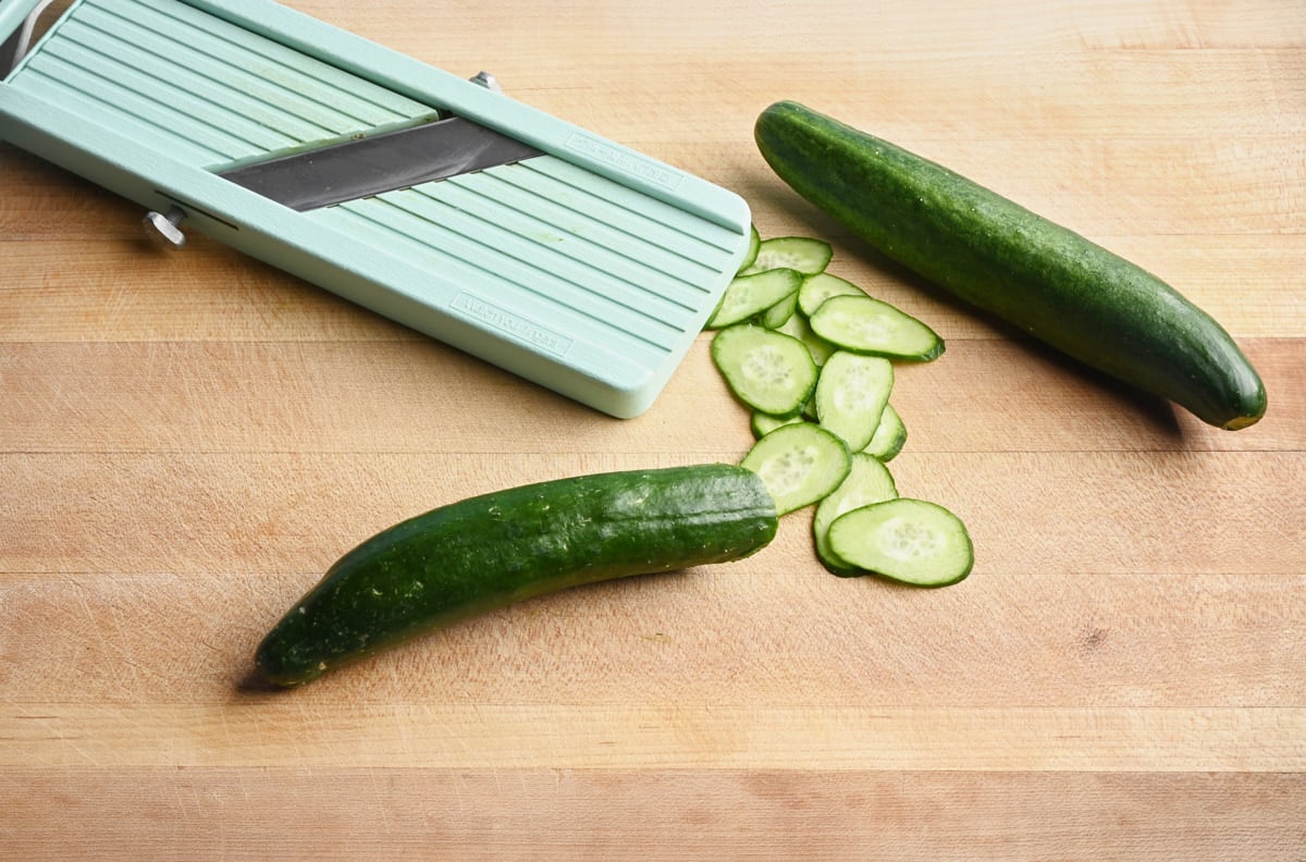 cucumbers, cucumber slices and a mandolin