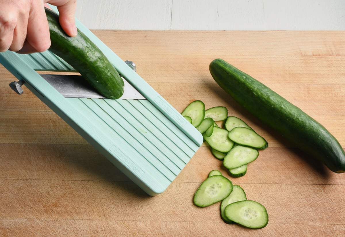 slicing cucumber on a mandolin