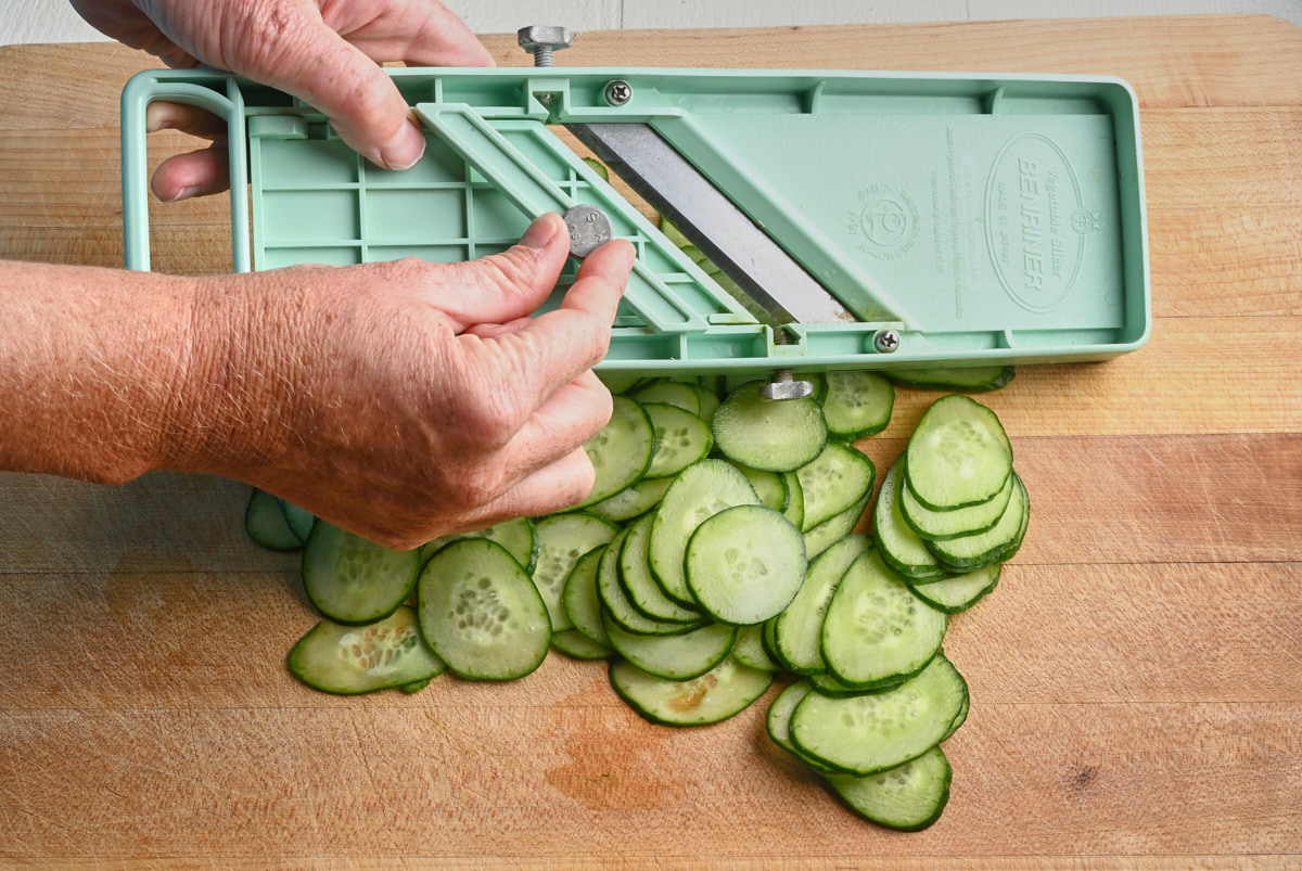 mandolin setting beside sliced cucumber