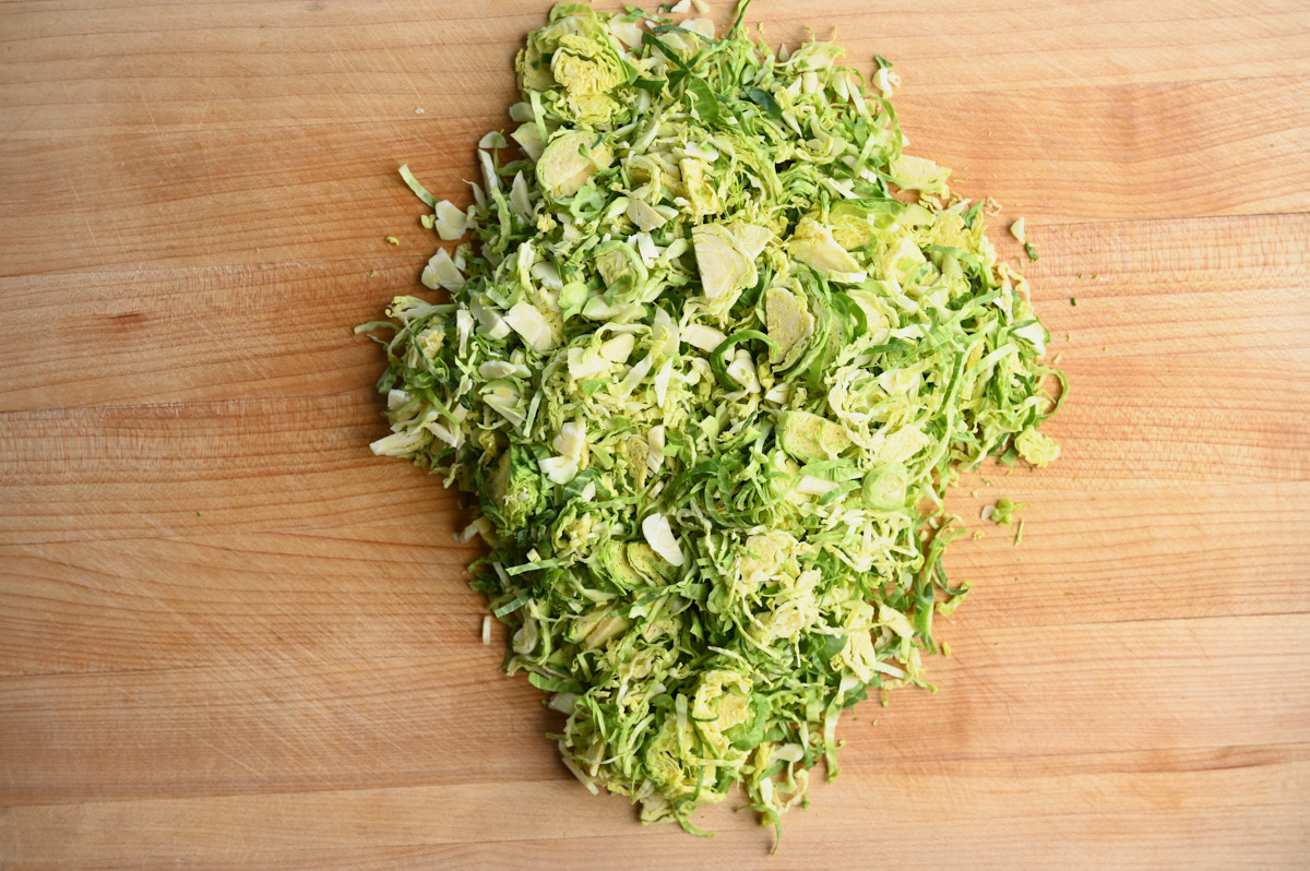 Shredded Brussel Sprouts on a wooden cutting board