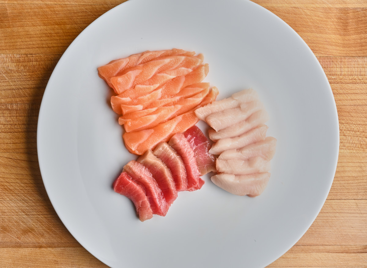 sliced raw sashimi on a white plate