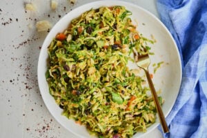 Finished bowl of Brussels sprouts salad with vibrant ingredients.