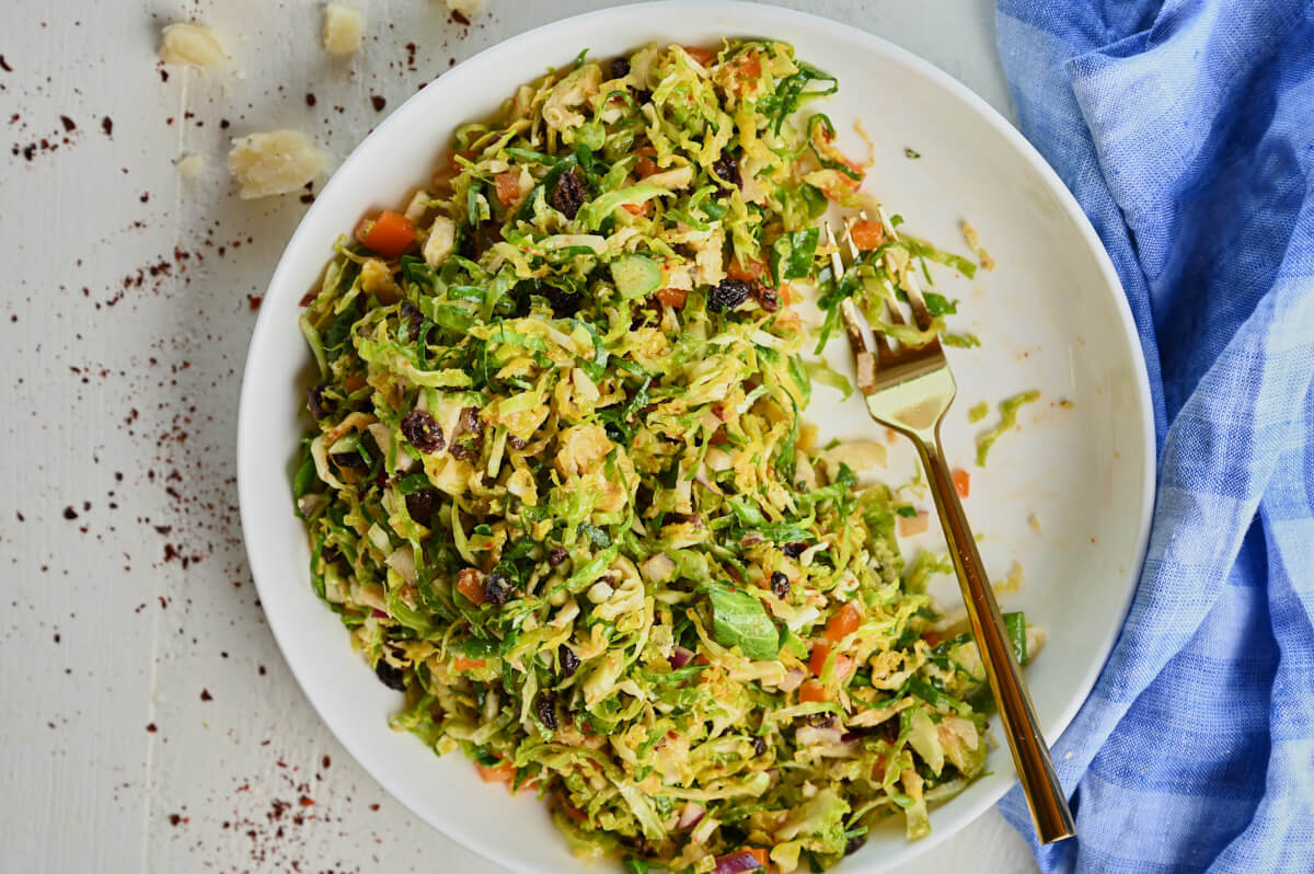 Finished bowl of Brussels sprouts salad with vibrant ingredients.