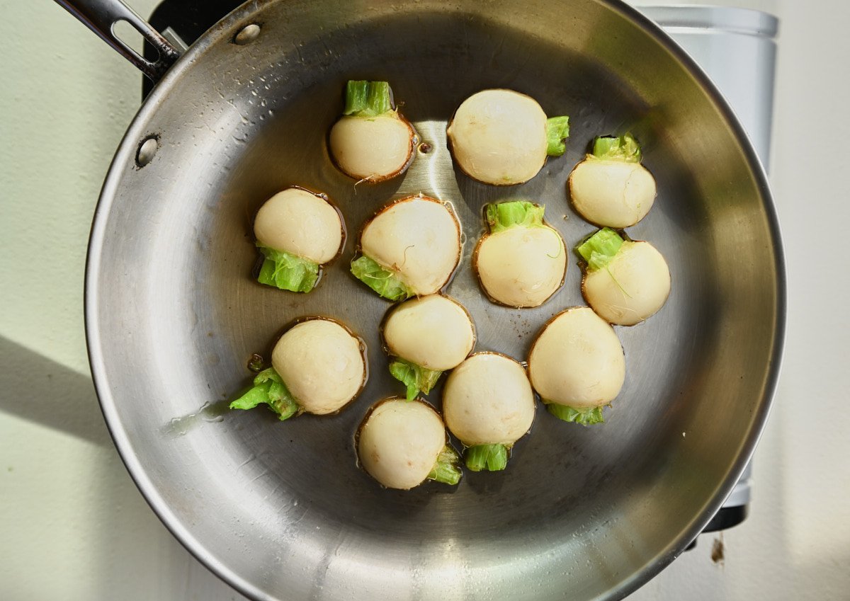 turnips sautéing in a pan