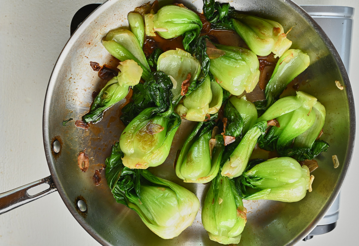 Sauteing baby bok choy and garlic carmelizing.