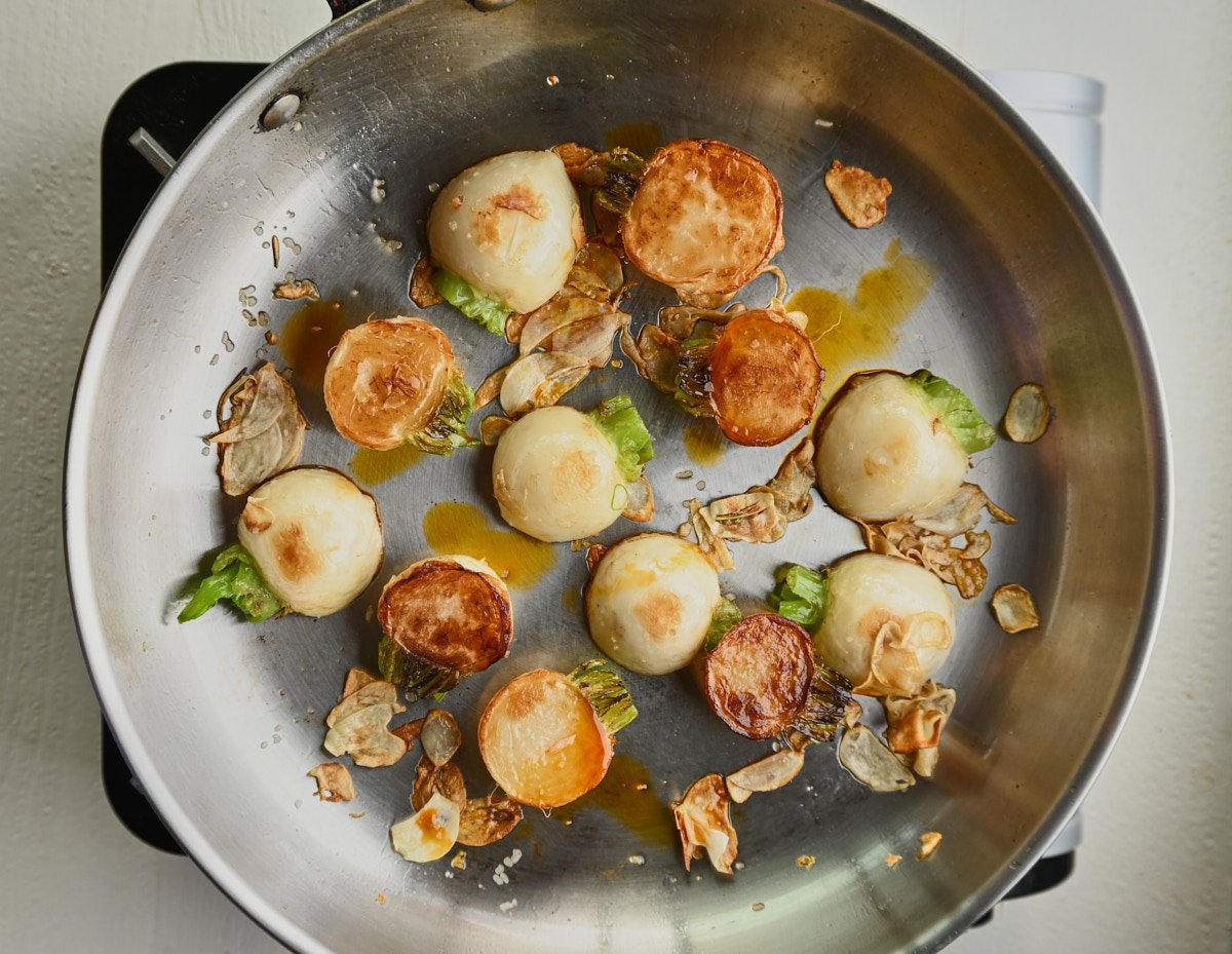 caramelized turnips and garlic in a pan 