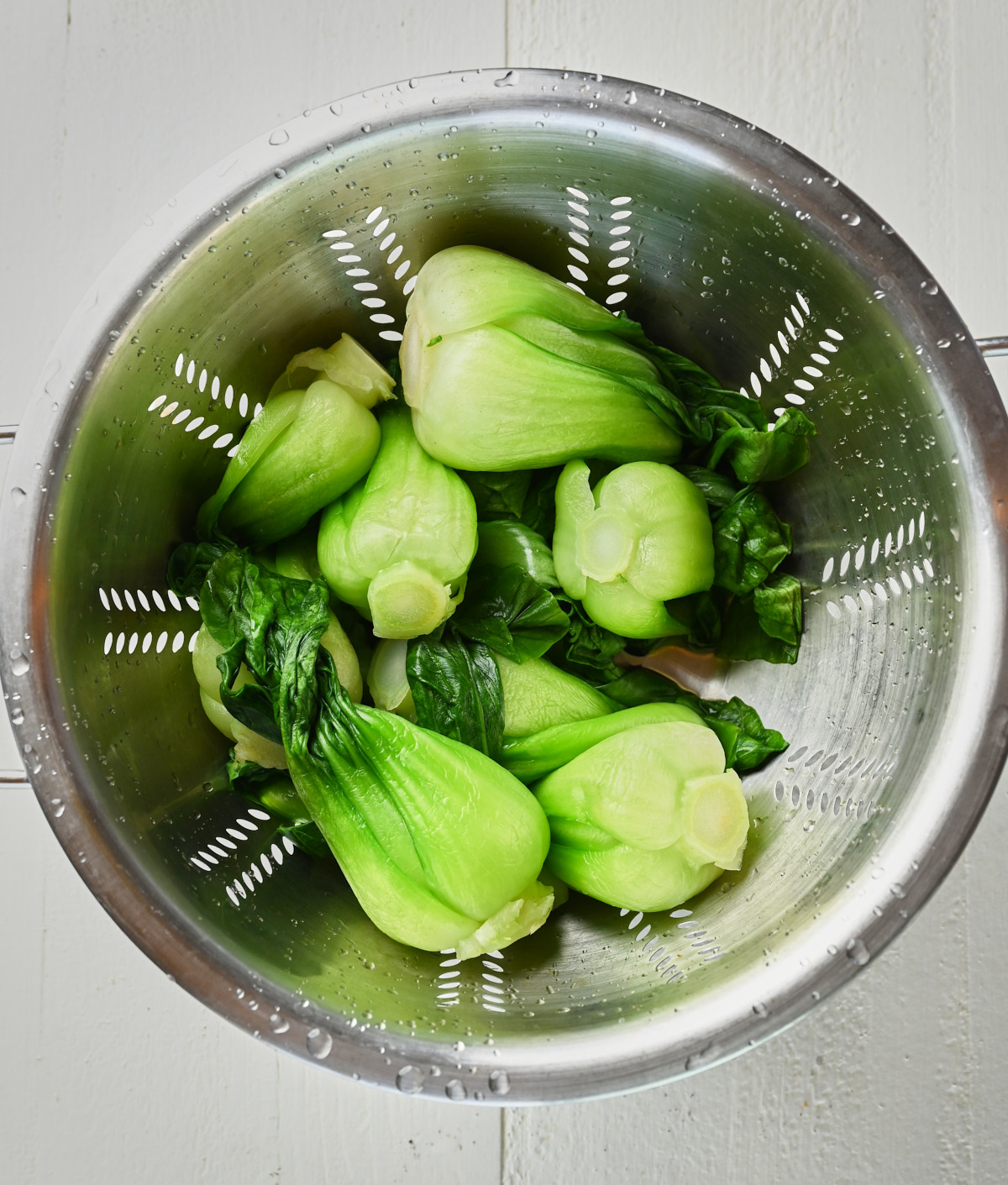 fresh baby bok choy in a colander