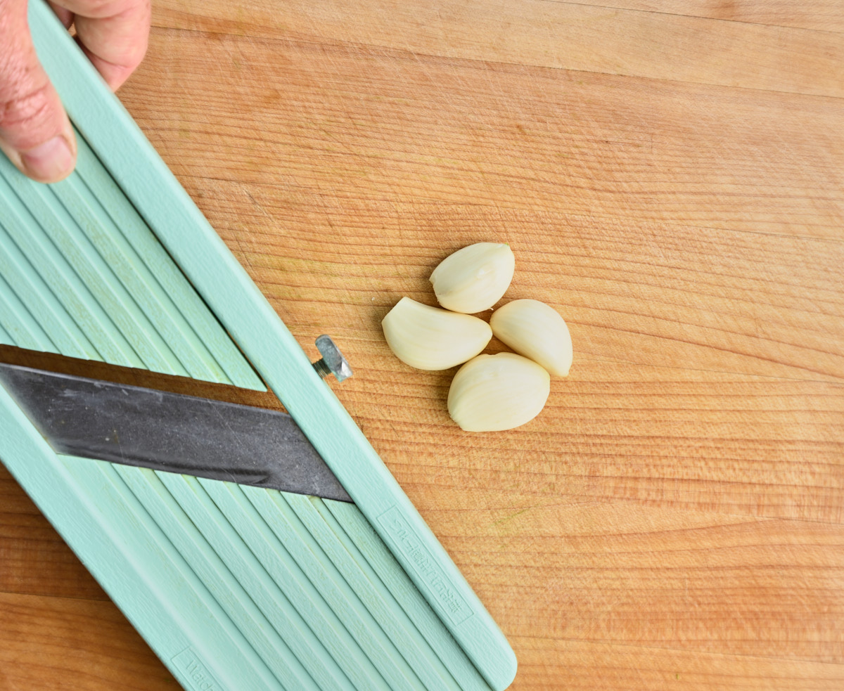 mandolin next to garlic cloves