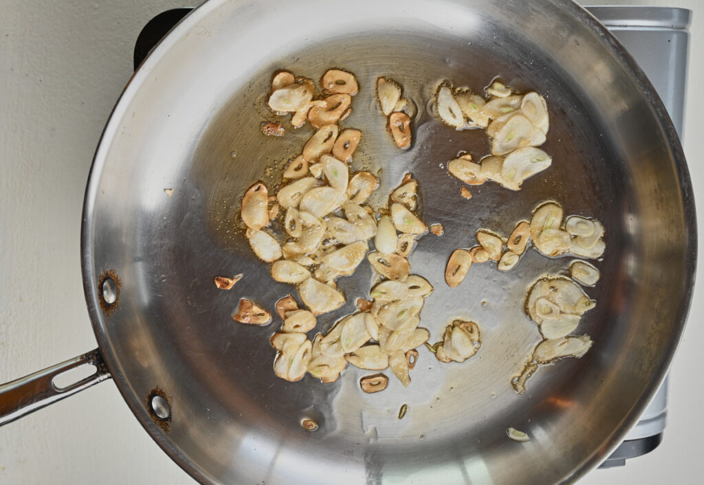Garlic and oil sauteing in a pan