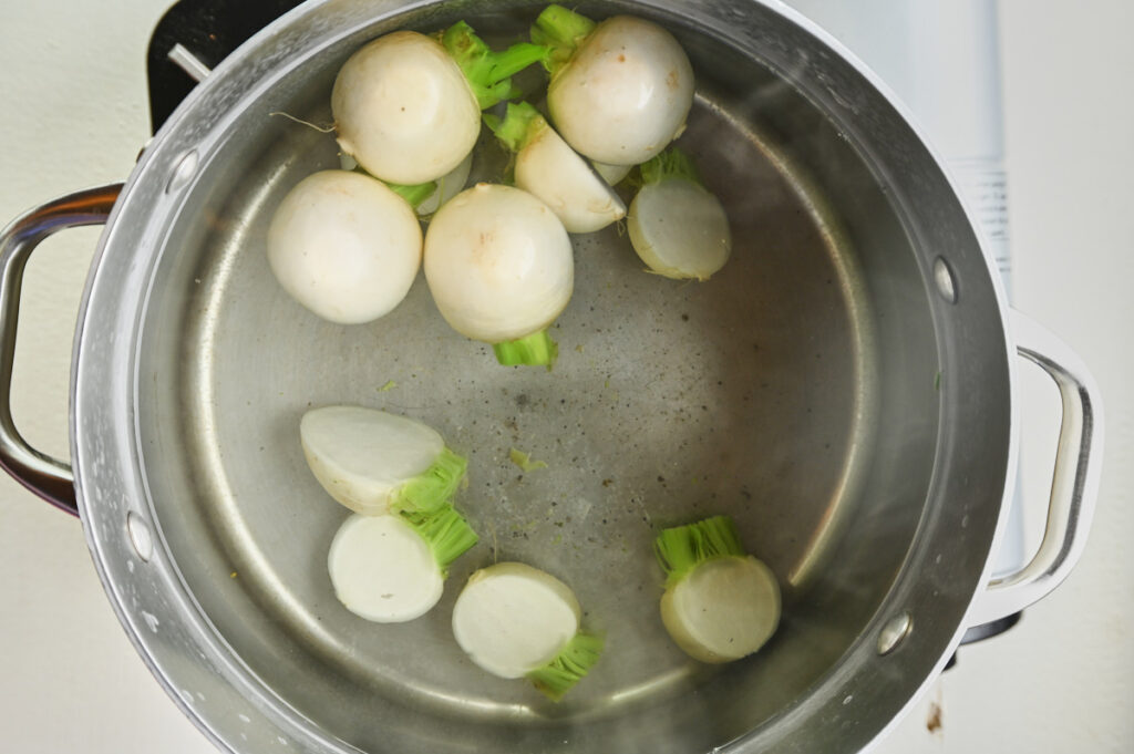 turnips blanching in a pot of boiling water