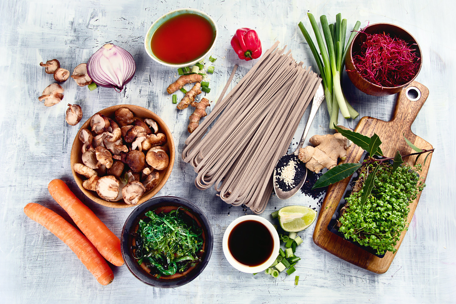 ingredients you would find in an Asian pantry laid out on a whitewashed table.