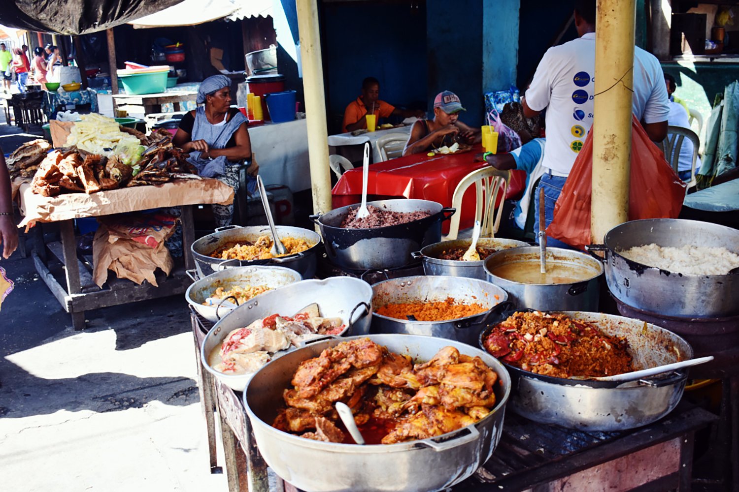 traditional food cooking on an outdoor patio with people eating