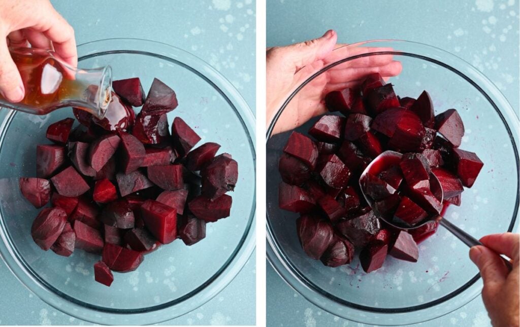 Pouring red wine vinegar over roasted beets and mixing them in a glass bowl.