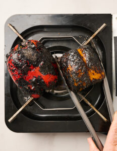 Charred peppers on an open flame