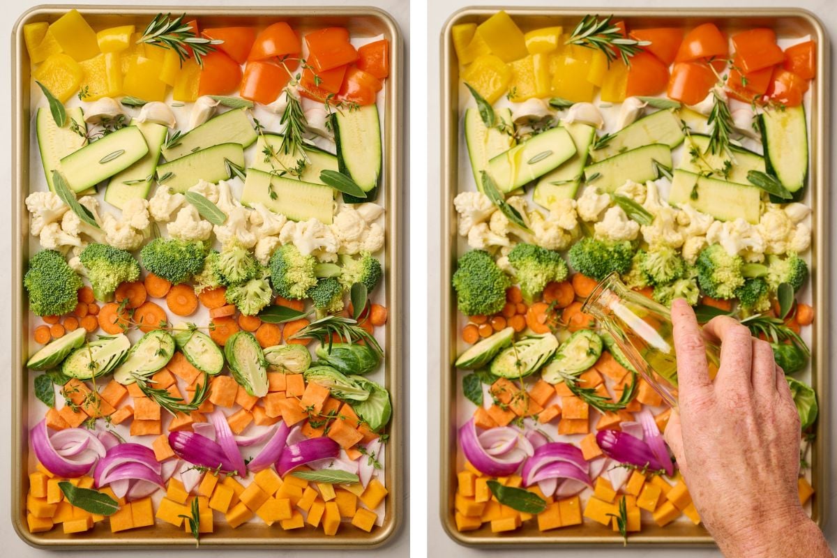 Sheet pan of raw vegetables arranged in a single layer with a hand drizzling olive oil
