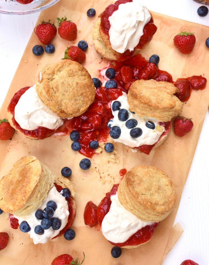 strawberry shortcake biscuits with maple cream and strawberry jam, with blueberry garnish